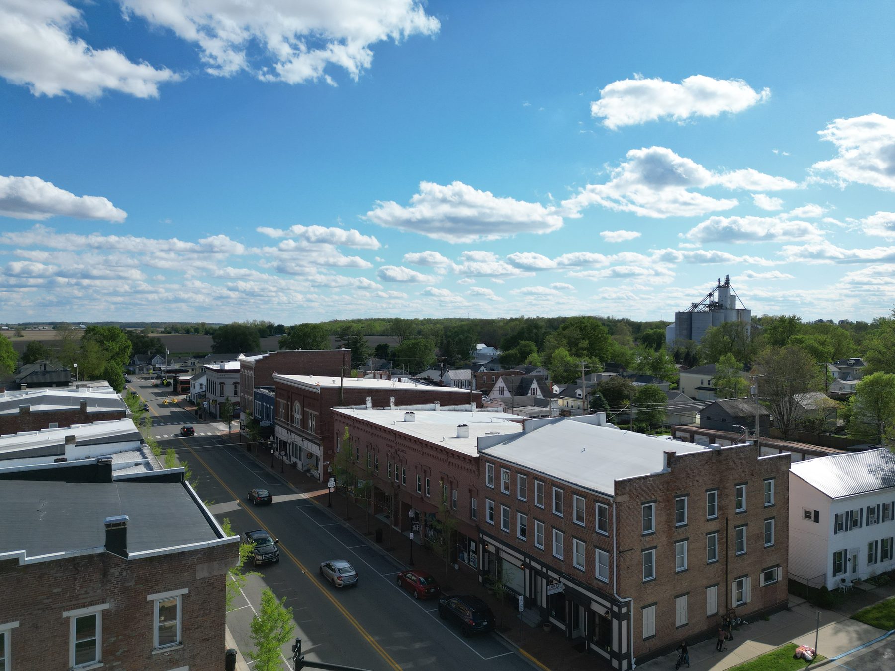 The business district from above, brick storefronts along the street with the grain elevator standing at the far end