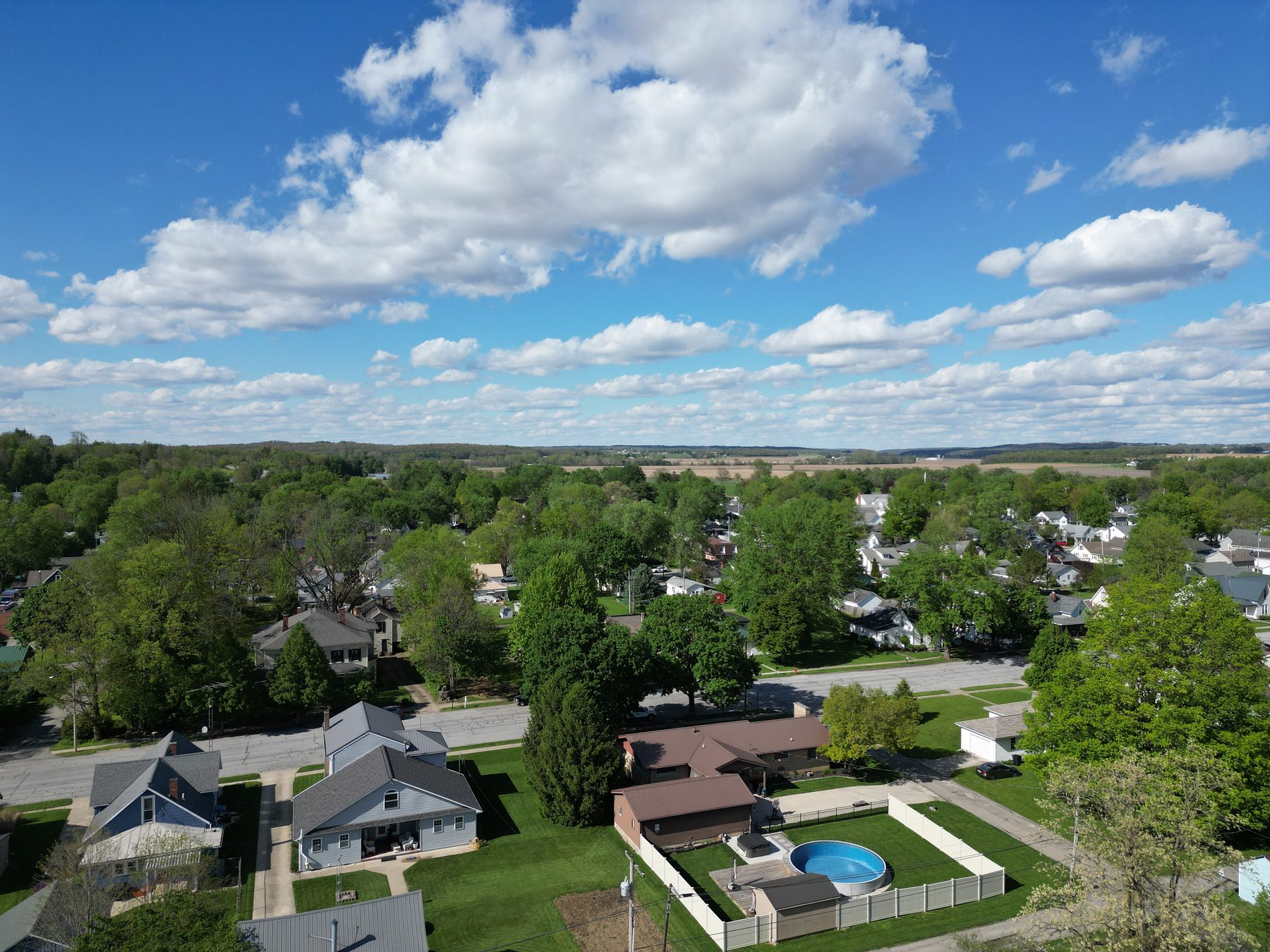 Residential blocks in West Liberty from above, houses, back yards and mature trees along quiet streets